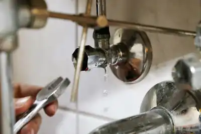 Leaking water heater valve being repaired by a licensed plumber in Newberg, Oregon